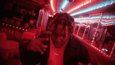 Man In Red Shirt In Dark Room With Neon Lights GIF