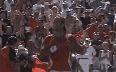 Man In Red Shirt In Front Of Crowd GIF