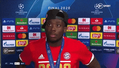 Man In Red Shirt In Front Of Final 2020 Backdrop GIF
