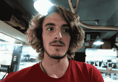 Man In Red Shirt In Front Of Sony Display GIF