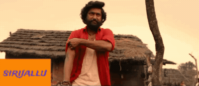 Man In Red Shirt In Front Of Thatched Building Saying Siriallu GIF