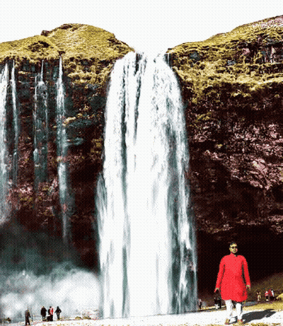 Man In Red Shirt In Front Of Waterfall GIF