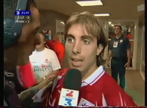 Man In Red Shirt Interviewed By Man With Microphone 3 GIF
