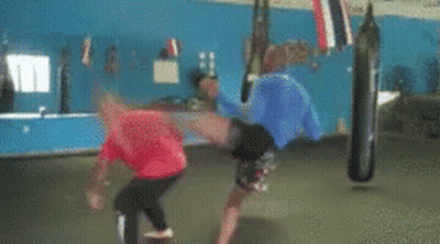 Man in Red Shirt Kicking Man in Blue Shirt