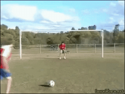 Man In Red Shirt Kicking Soccer Ball GIF
