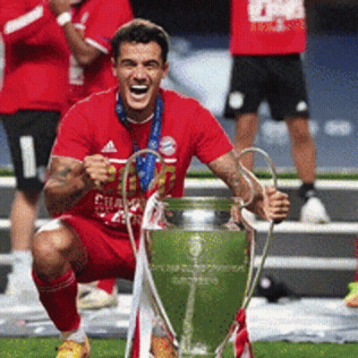 Man In Red Shirt Kneeling With Trophy GIF