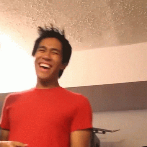 Man In Red Shirt Laughing With Skateboard GIF
