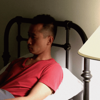 Man In Red Shirt Laying In Bed GIF