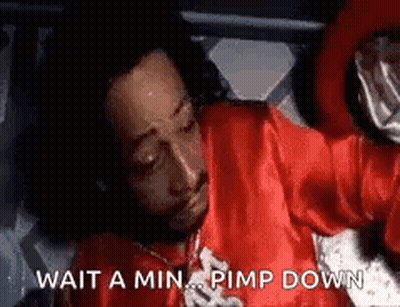 Man In Red Shirt Laying On Bed Saying Wait A Min Pimp Down GIF