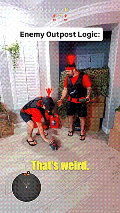 Man In Red Shirt Next To Man In Black Vest GIF