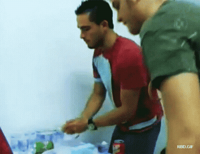 Man In Red Shirt Next To Man In Green Shirt With Coca Cola GIF