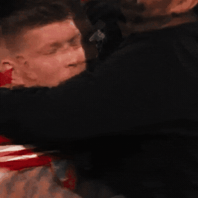Man In Red Shirt Number 3 Hugged By Another Man GIF