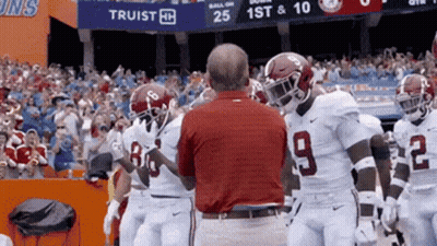 Man In Red Shirt Number 9 Talks To Football Players GIF