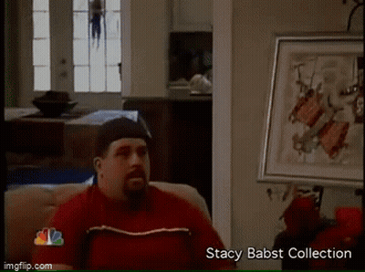 Man In Red Shirt On Couch Beside Stacy Babst Collection Framed Picture GIF