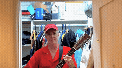 Man In Red Shirt Playing Guitar In Closet With Flybridge Box GIF