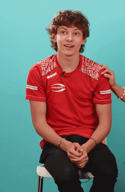 Man In Red Shirt Prestige Sitting On Chair GIF