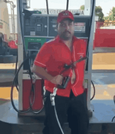 Man In Red Shirt Pumping Gas GIF