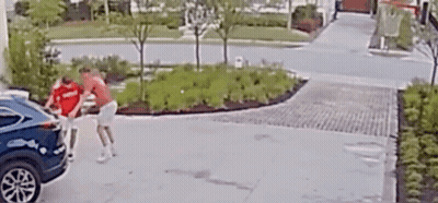 Man In Red Shirt Pushing Blue Car In Driveway GIF