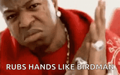 Man In Red Shirt Rubs Hands Like Birdman GIF
