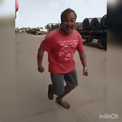 Man In Red Shirt Running Down Road GIF