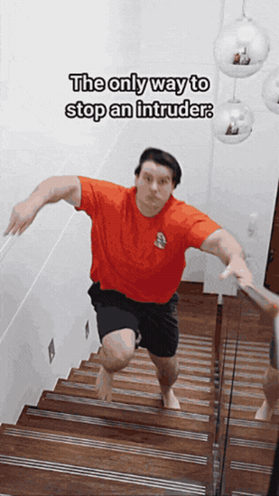 Man In Red Shirt Running Down Stairs GIF