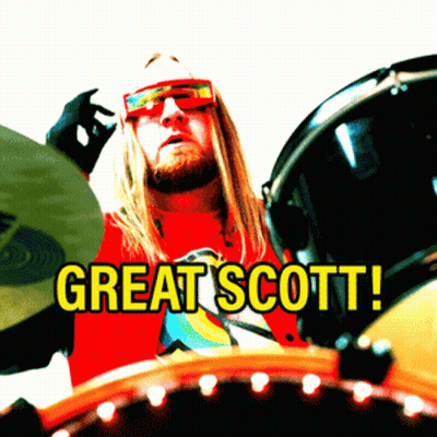 Man In Red Shirt Saying Great Scott Playing Drums GIF