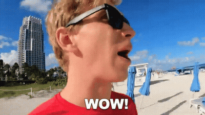 Man In Red Shirt Saying Wow On Beach GIF