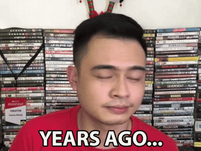 Man In Red Shirt Saying Years Ago In Front Of DVDs GIF