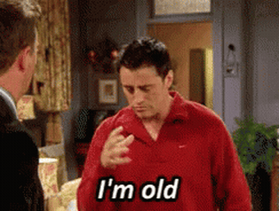 Man In Red Shirt Says I'm Old To Another Man GIF
