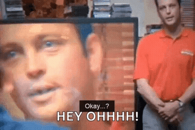 Man In Red Shirt Says Okay At Screen With Face GIF