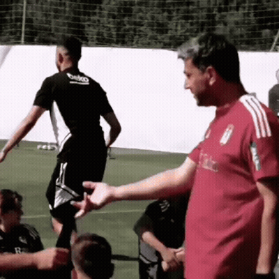 Man In Red Shirt Shaking Hands With Soccer Player GIF