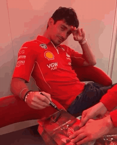 Man In Red Shirt Signing Book GIF