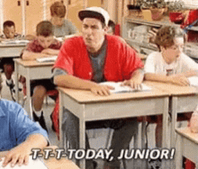 Man In Red Shirt Sitting At Desk In Classroom GIF
