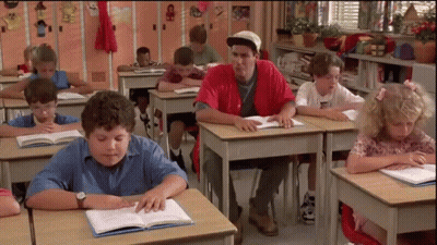 Man In Red Shirt Sitting At Desk With Children GIF