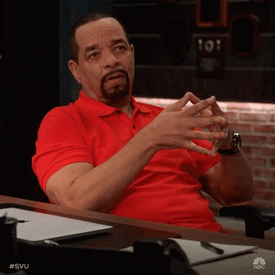 Man In Red Shirt Sitting At Desk With Hands Together GIF