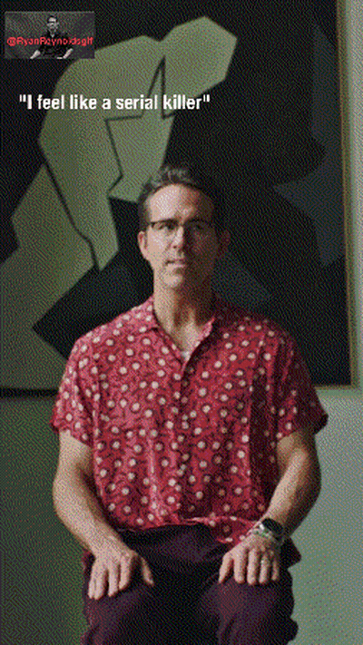 Man In Red Shirt Sitting In Front Of Painting GIF