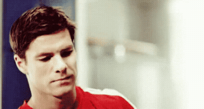 Man In Red Shirt Sitting In Locker Room GIF