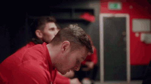 Man In Red Shirt Sitting GIF