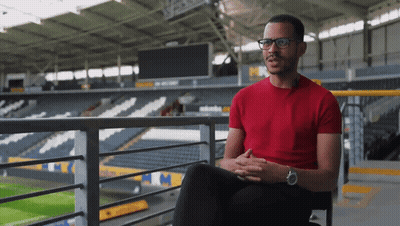 Man In Red Shirt Sitting On Balcony GIF
