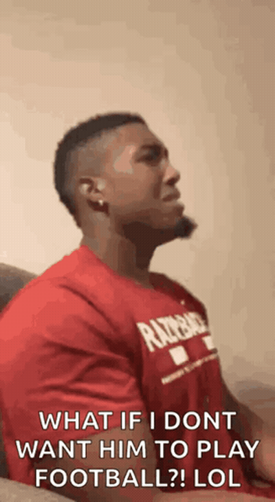 Man In Red Shirt Sitting On Couch Talking GIF