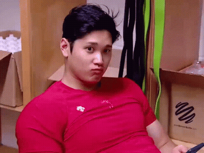 Man In Red Shirt Sitting With Cell Phone GIF