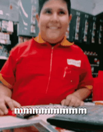 Man In Red Shirt Smiling Holding Calculator GIF