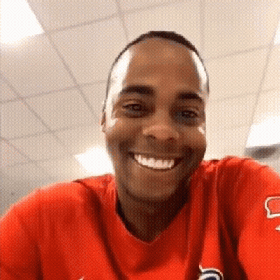 Man In Red Shirt Smiling Taking Selfie GIF