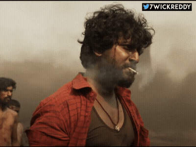 Man In Red Shirt Smoking With Hashtag 7Wickreddy GIF