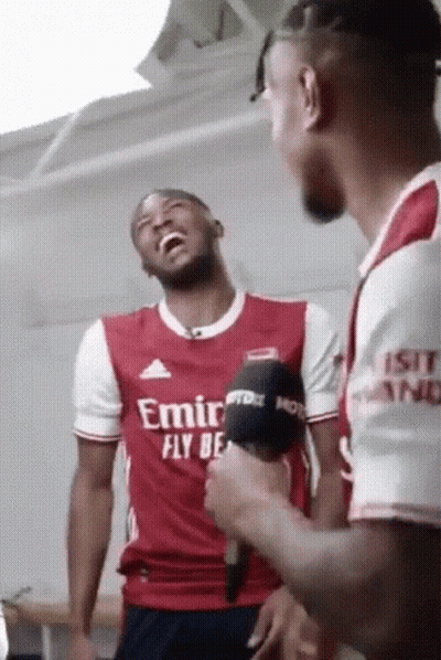 Man In Red Shirt Speaking Into Microphones GIF