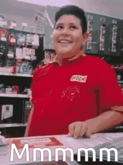 Man In Red Shirt Standing At Store Counter GIF