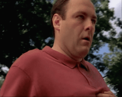 Man In Red Shirt Standing Before Trees GIF