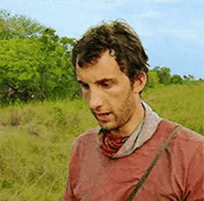 Man In Red Shirt Standing In Field GIF