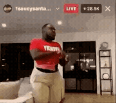 Man In Red Shirt Standing In Living Room GIF