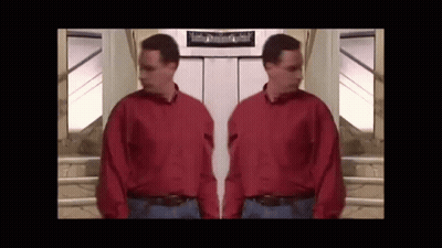 Man In Red Shirt Standing Next To Another Man GIF